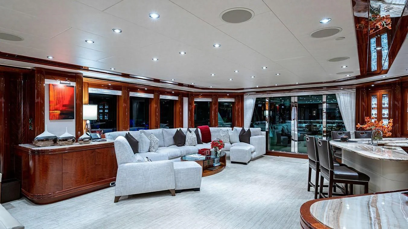 a living room with a large white sofa and a large table aboard NIGHT HOWL Yacht for Sale