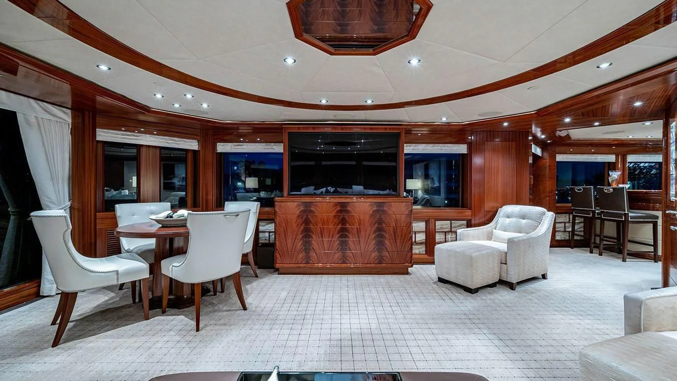 a room with a table chairs and a tv aboard NIGHT HOWL Yacht for Sale