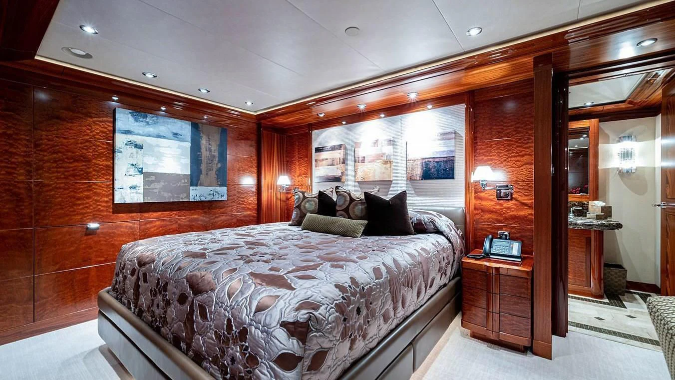 a bedroom with a bed and a desk aboard NIGHT HOWL Yacht for Sale
