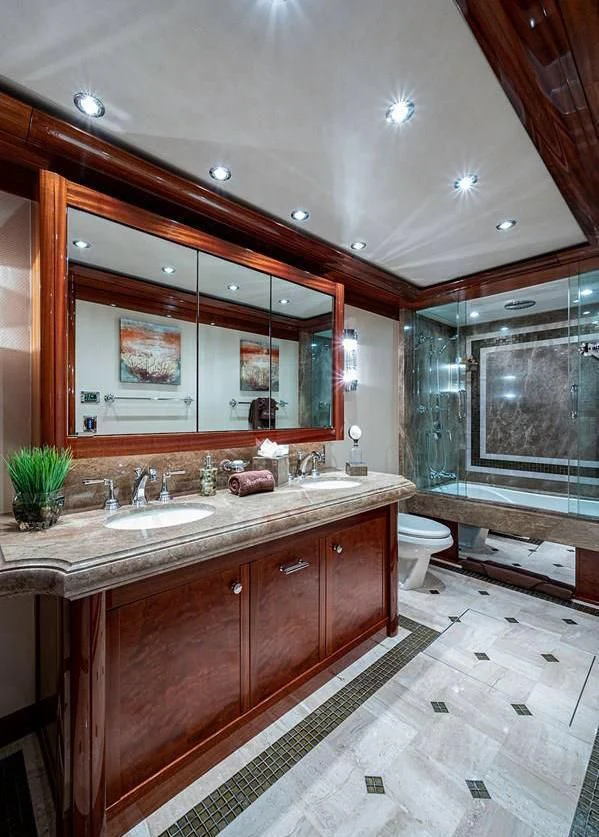 a bathroom with a large mirror aboard NIGHT HOWL Yacht for Sale