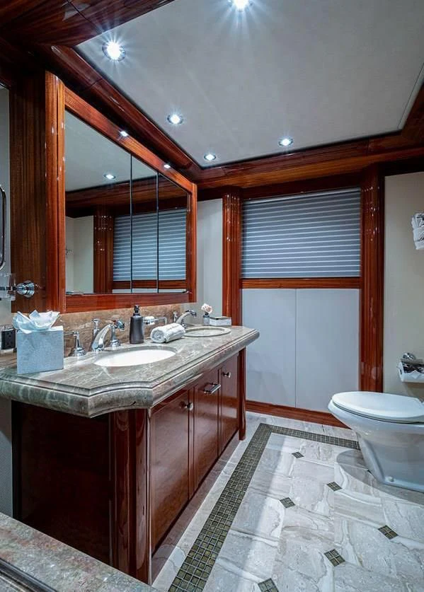 a bathroom with a sink and a mirror aboard NIGHT HOWL Yacht for Sale