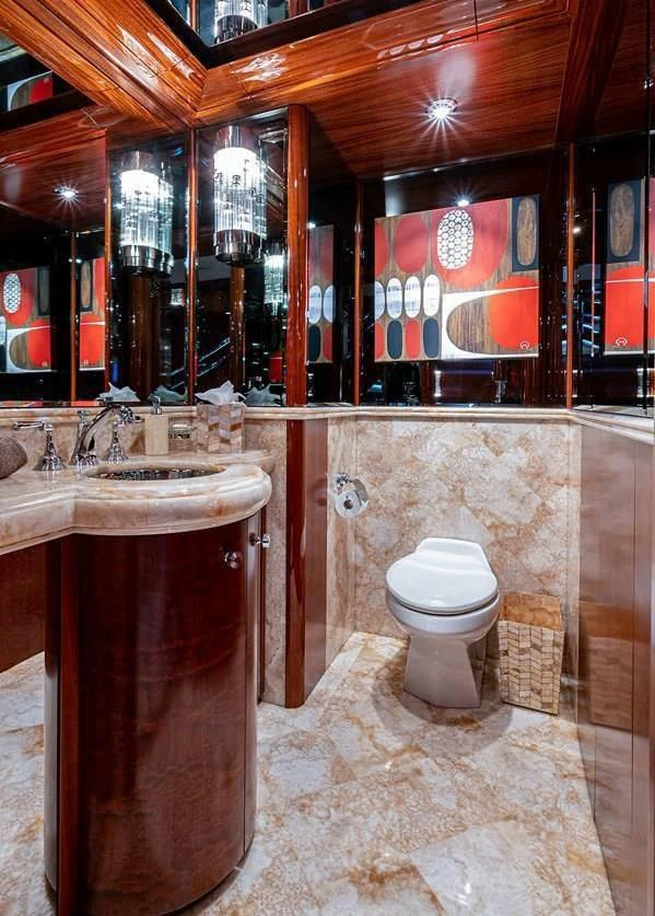 a bathroom with a toilet and sink aboard NIGHT HOWL Yacht for Sale