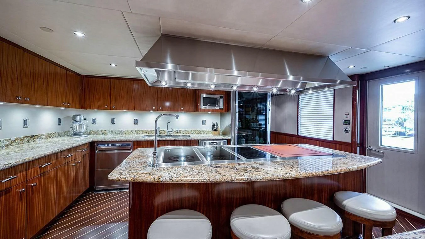 a large kitchen with wooden cabinets aboard NIGHT HOWL Yacht for Sale