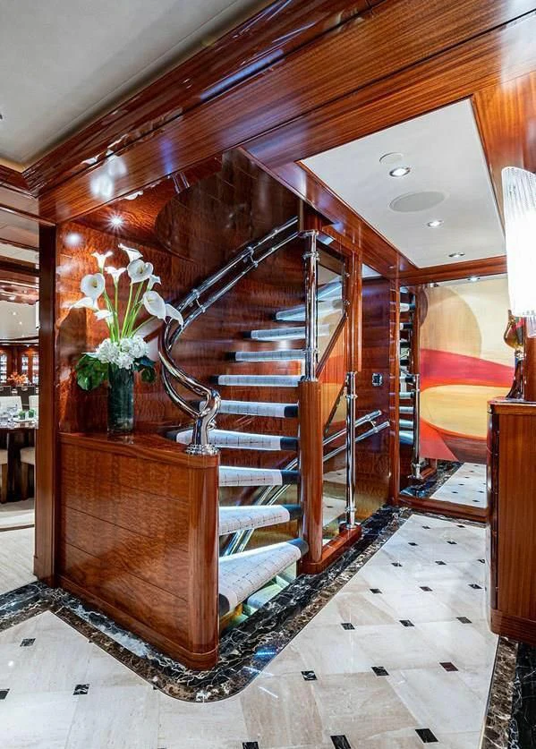 a wooden staircase in a house aboard NIGHT HOWL Yacht for Sale
