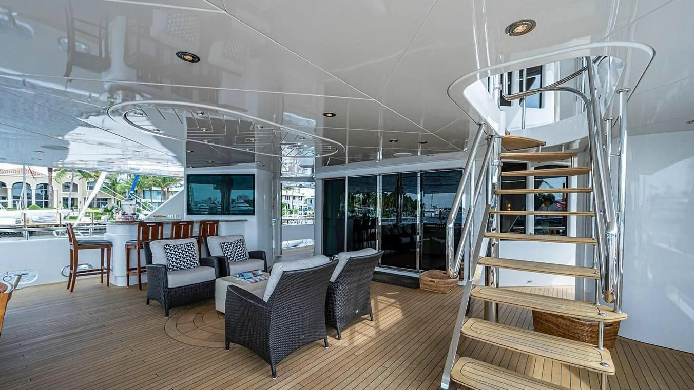 a room with a staircase and a couch and a table aboard NIGHT HOWL Yacht for Sale