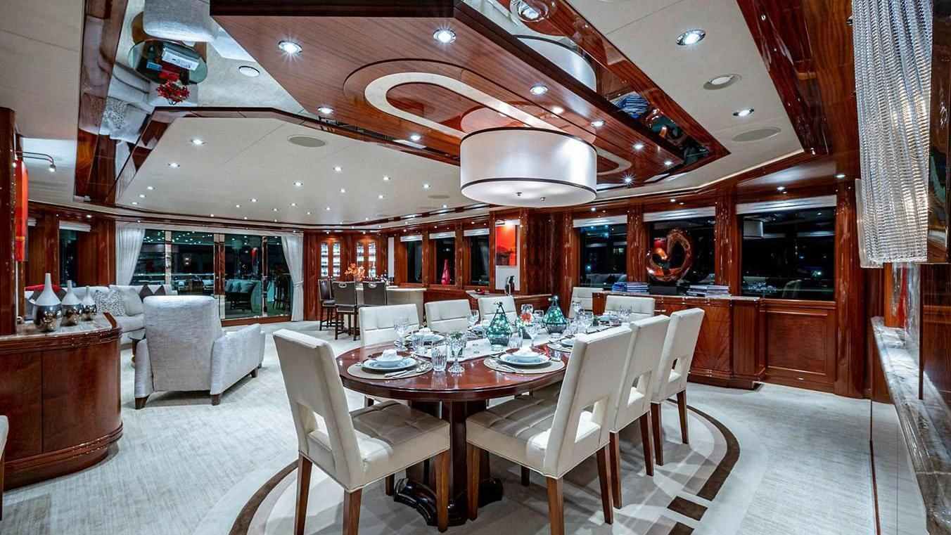 a large room with tables and chairs aboard NIGHT HOWL Yacht for Sale