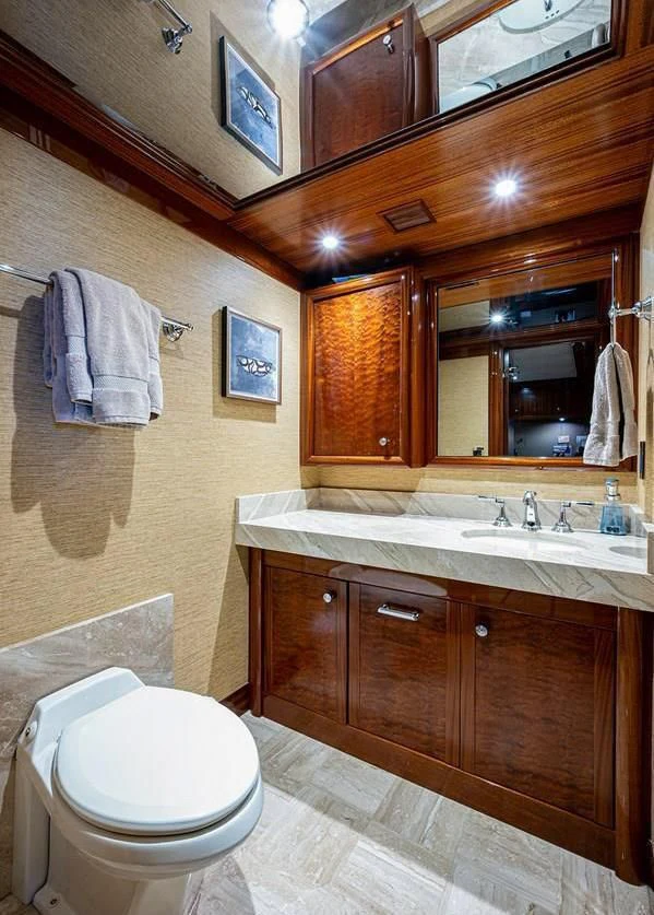 a bathroom with a toilet and a sink aboard NIGHT HOWL Yacht for Sale