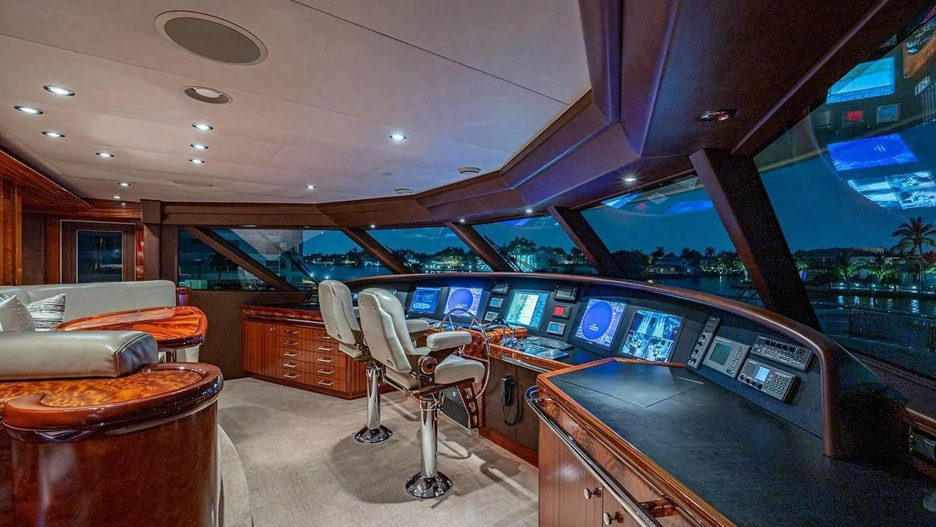 a room with a bar and a chair and a table with chairs aboard NIGHT HOWL Yacht for Sale