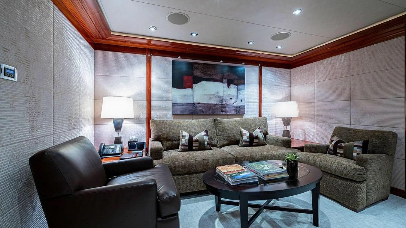 a living room with a couch and a coffee table aboard NIGHT HOWL Yacht for Sale