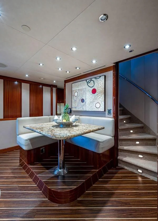 a room with a table and chairs aboard NIGHT HOWL Yacht for Sale