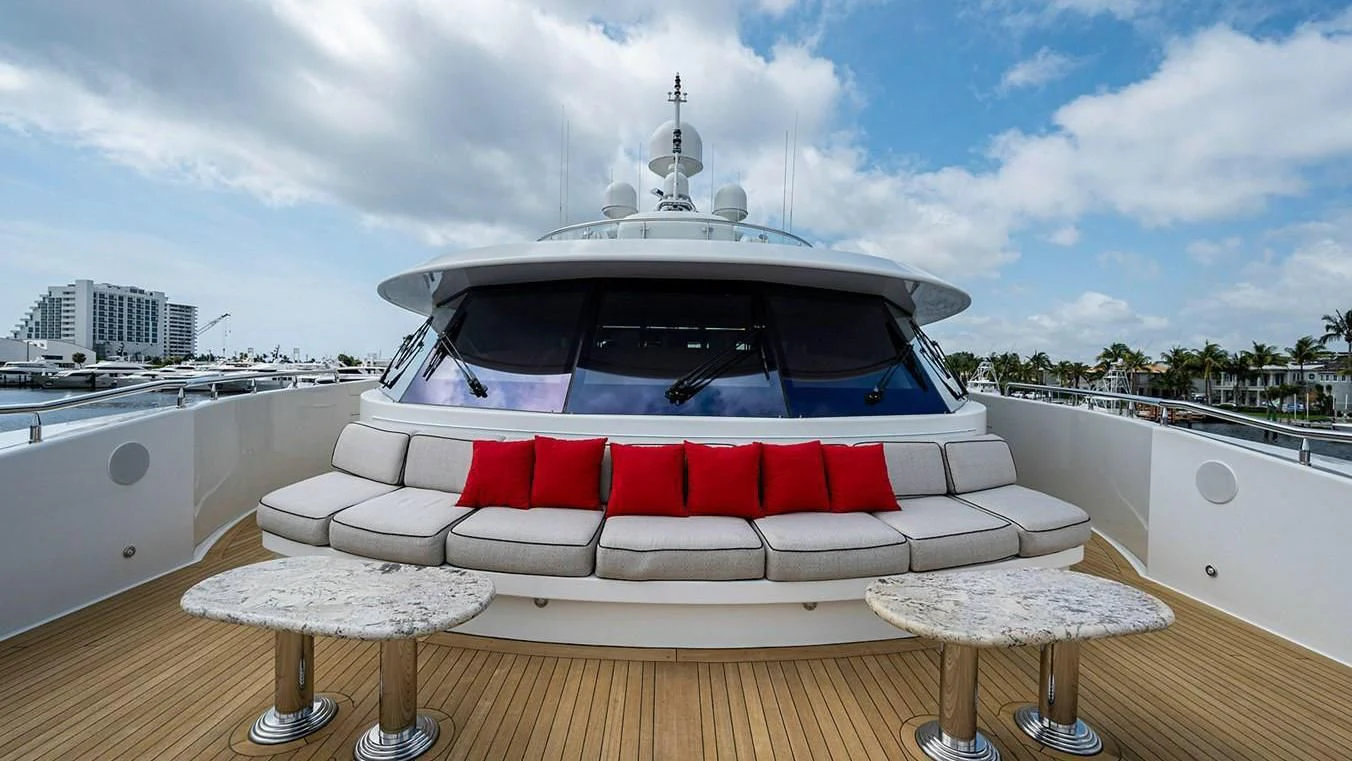 a white couch on a wooden floor aboard NIGHT HOWL Yacht for Sale