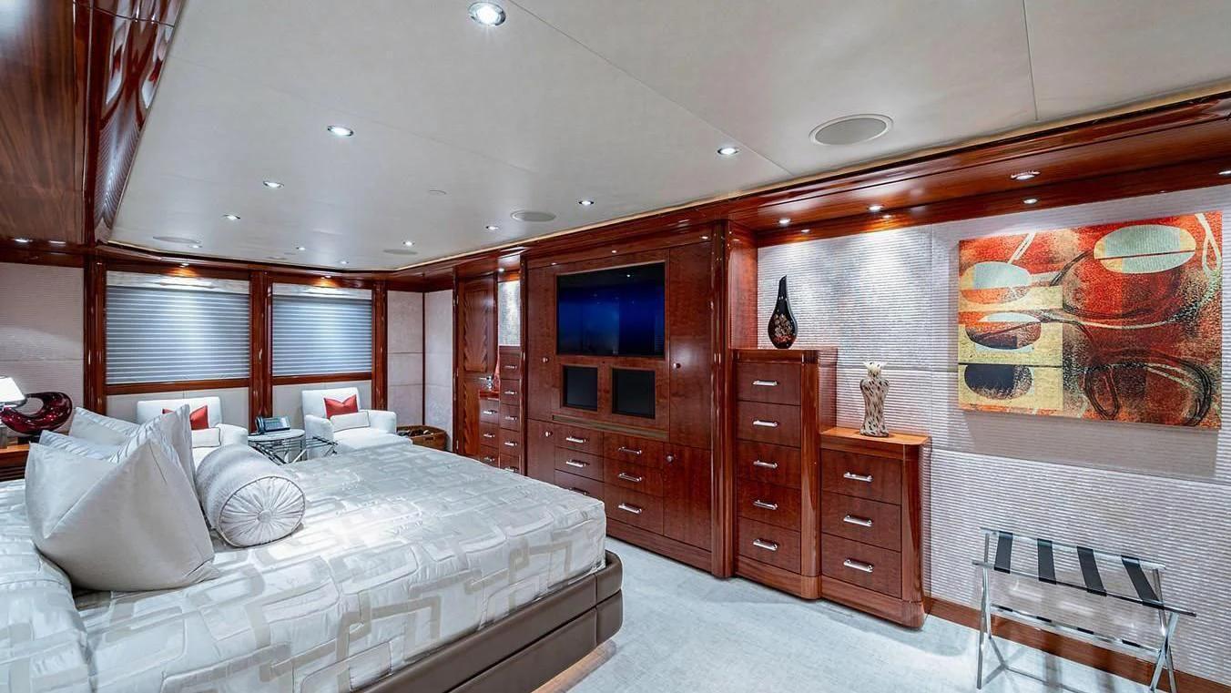 a bedroom with a bed and a dresser aboard NIGHT HOWL Yacht for Sale
