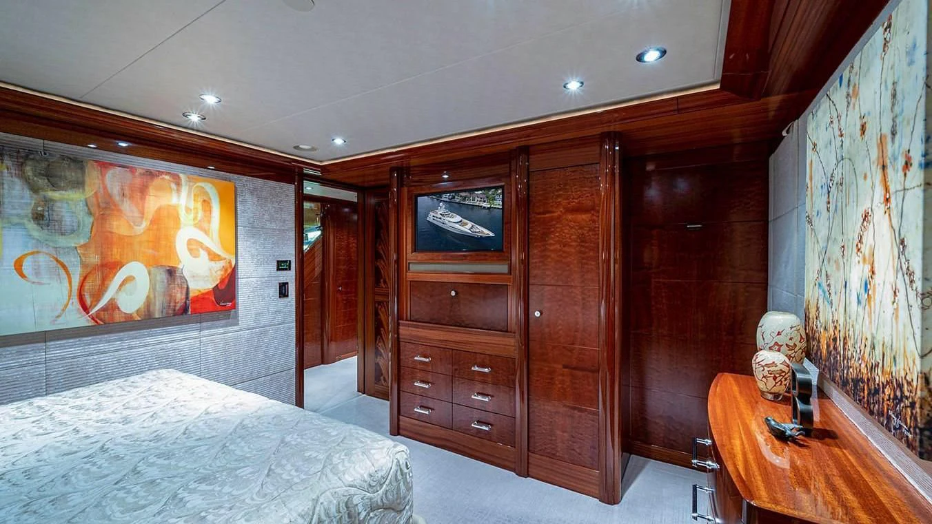 a bedroom with a bed and a desk aboard NIGHT HOWL Yacht for Sale