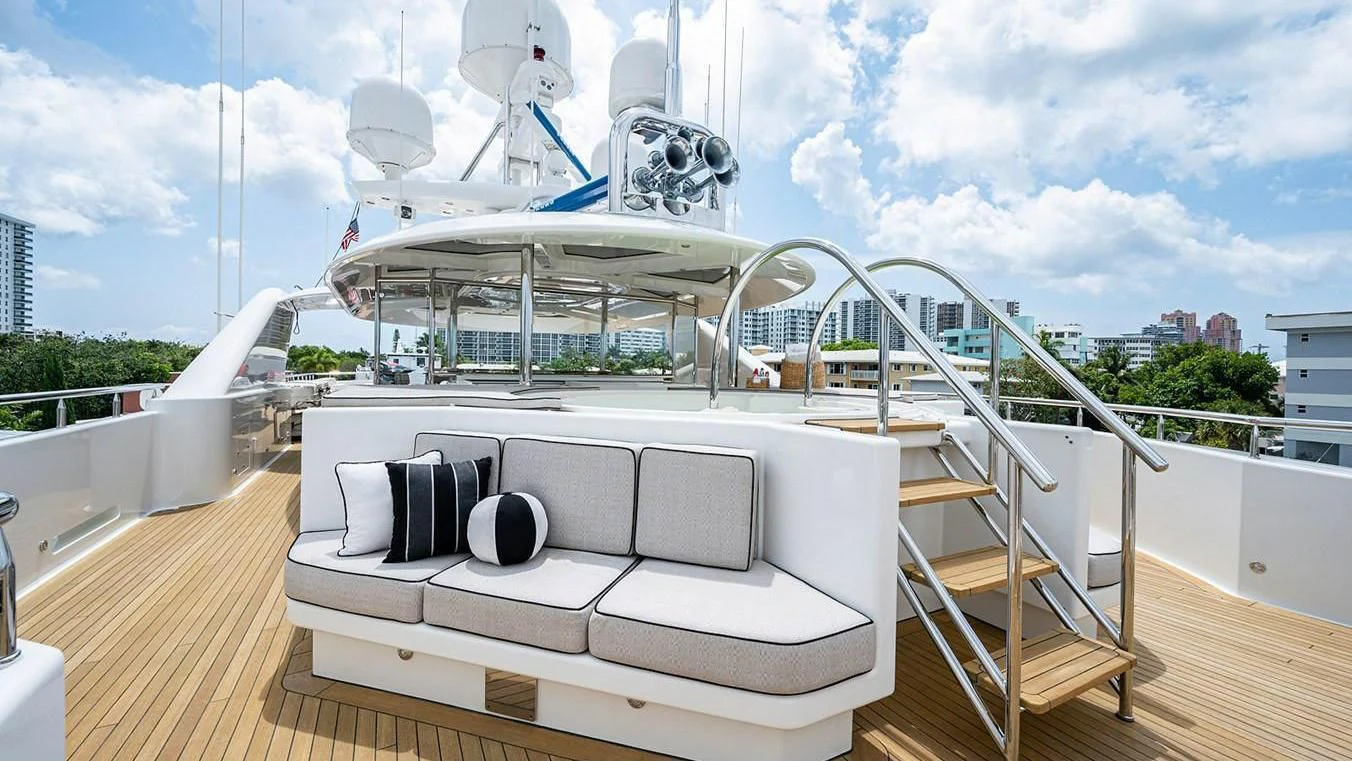 a deck with a slide and a building in the background aboard NIGHT HOWL Yacht for Sale