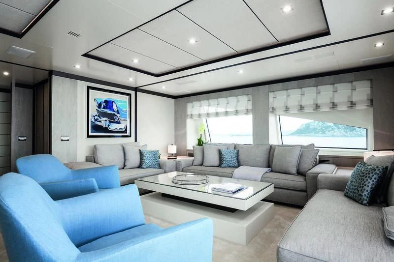 a living room with blue couches aboard WILLOW Yacht for Charter