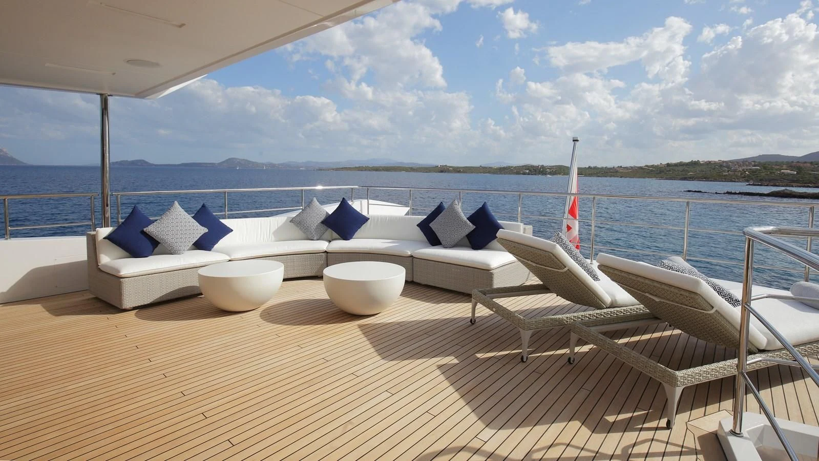 a deck with a view of the ocean and boats aboard WILLOW Yacht for Charter