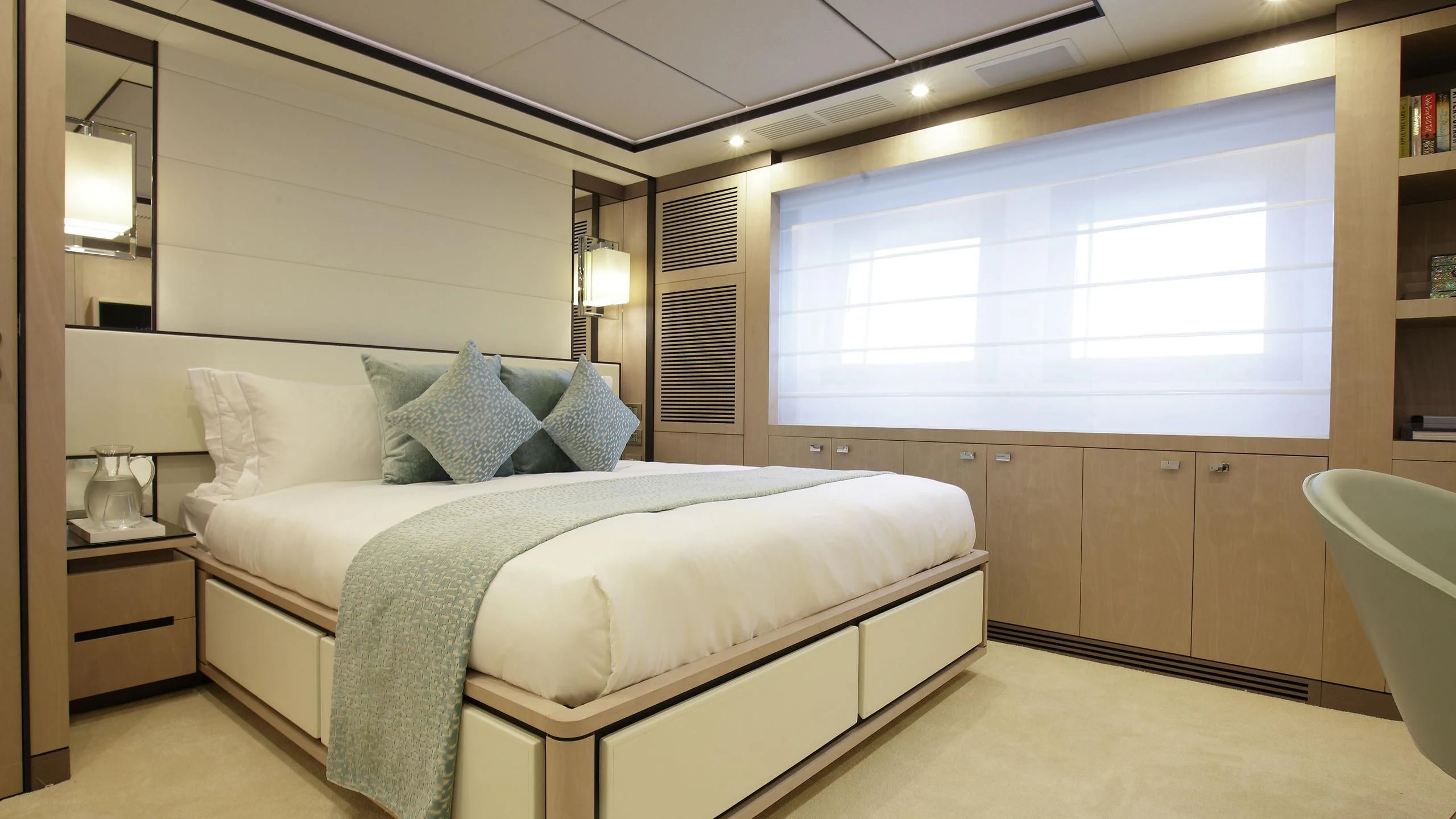 a bedroom with a bed and a window aboard WILLOW Yacht for Charter