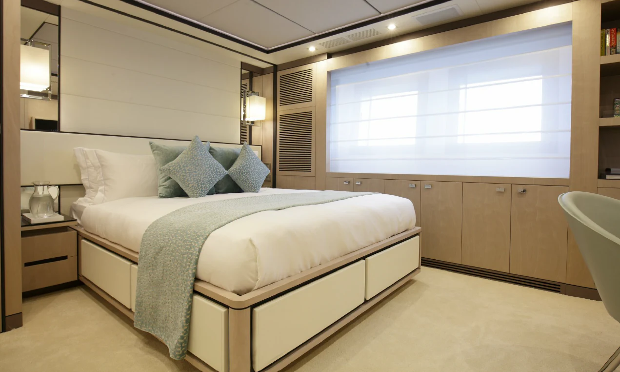 a bedroom with a bed and a window aboard WILLOW Yacht for Charter