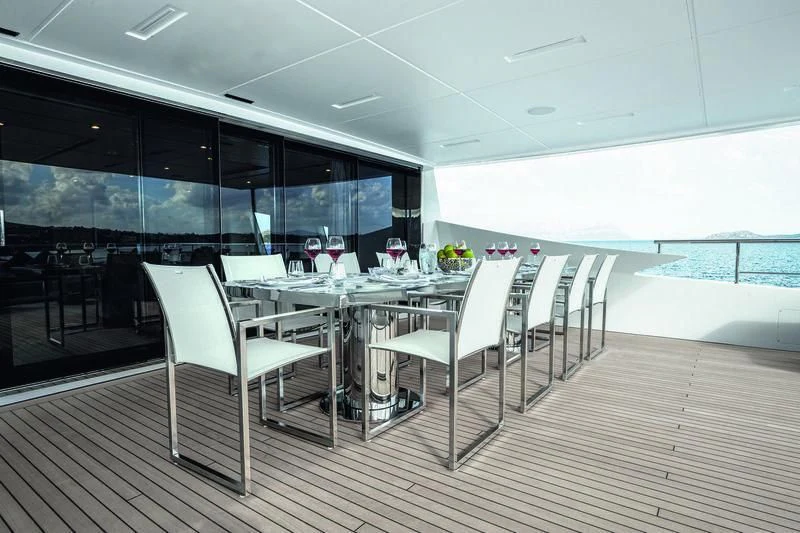 a room with tables and chairs aboard WILLOW Yacht for Charter