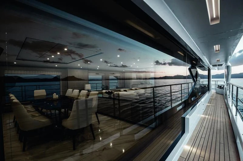 a deck with chairs and tables aboard WILLOW Yacht for Charter