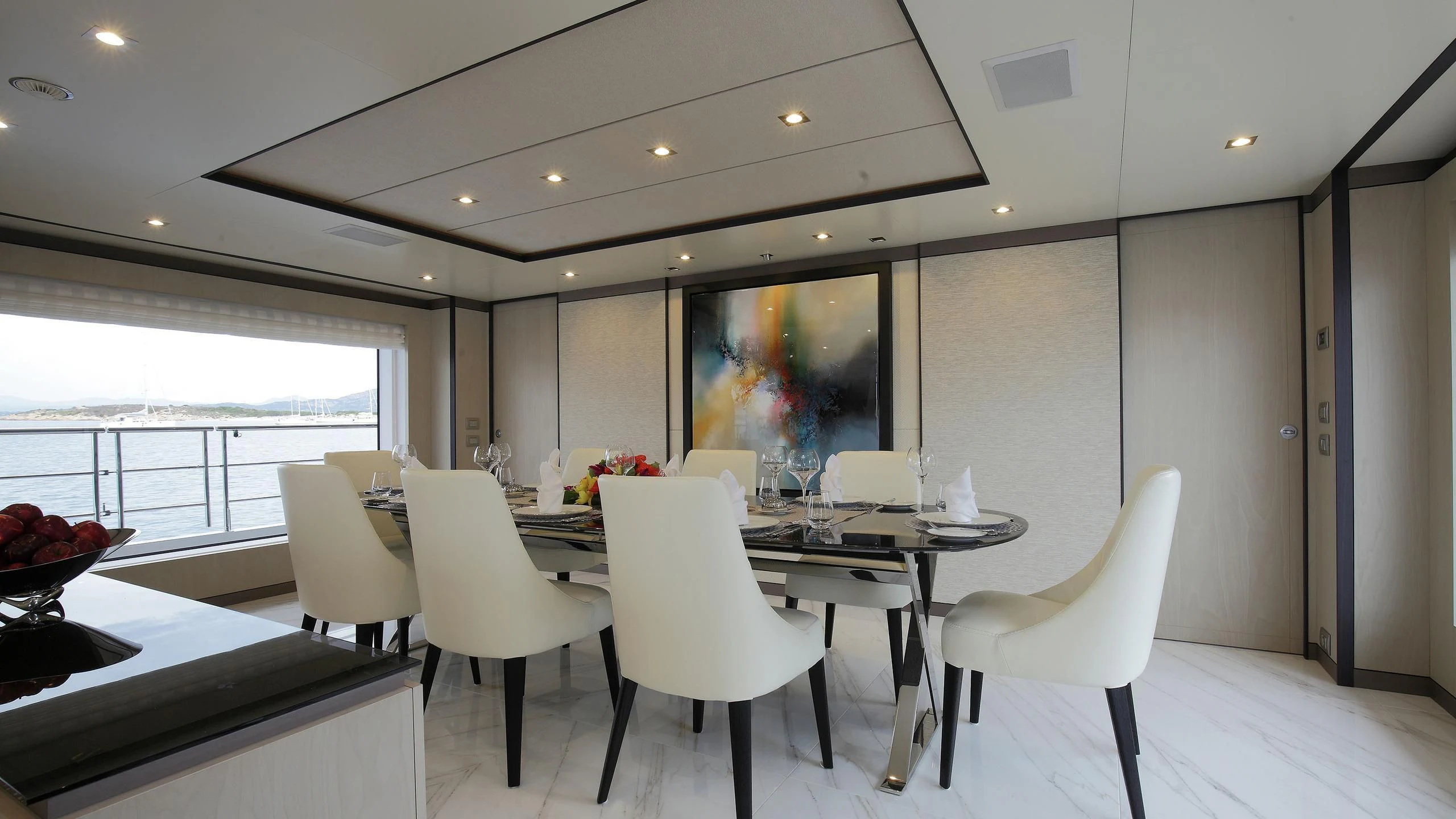 a room with white chairs and a table with white chairs aboard WILLOW Yacht for Charter