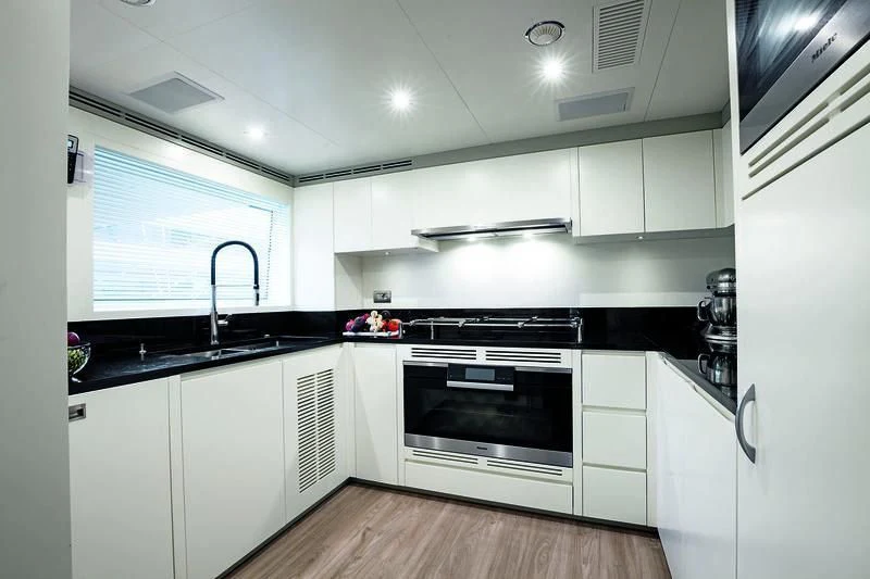 a kitchen with white cabinets aboard WILLOW Yacht for Charter