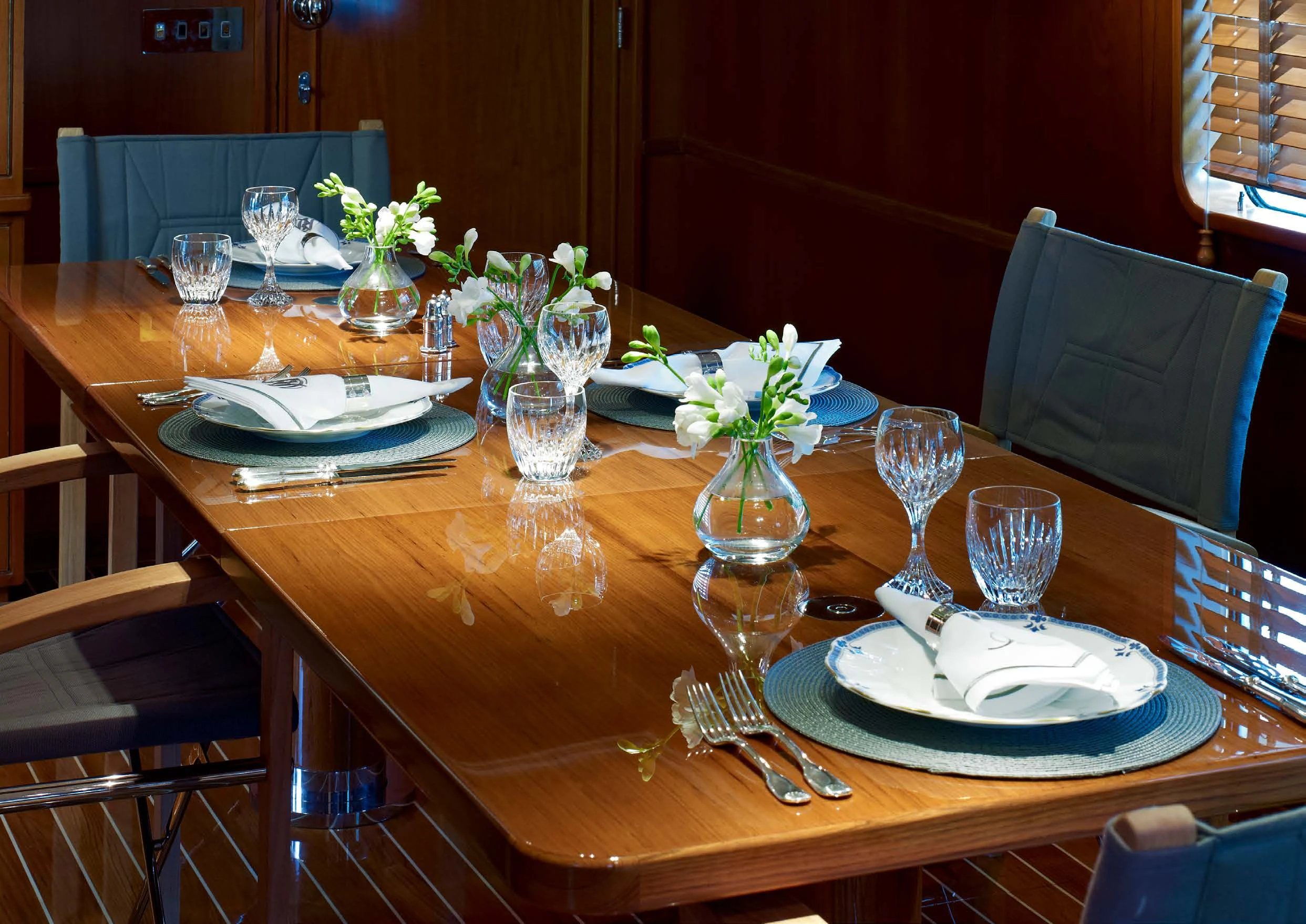 a table with plates and glasses on it aboard HEAVENLY DAZE Yacht for Sale