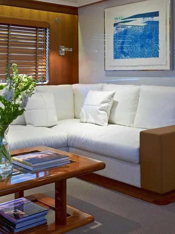 a white couch with a coffee table aboard HEAVENLY DAZE Yacht for Sale