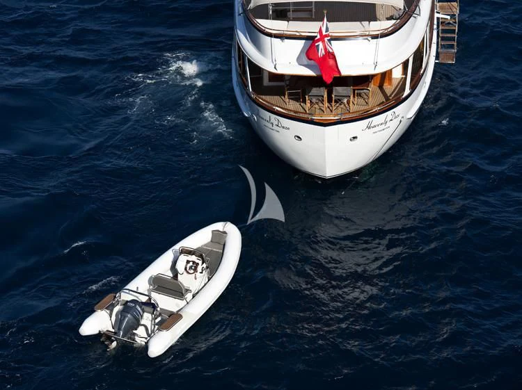 a boat and a motor boat in the water aboard HEAVENLY DAZE Yacht for Sale