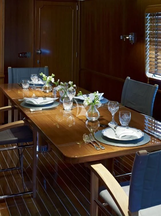 a table set with plates and glasses aboard HEAVENLY DAZE Yacht for Sale