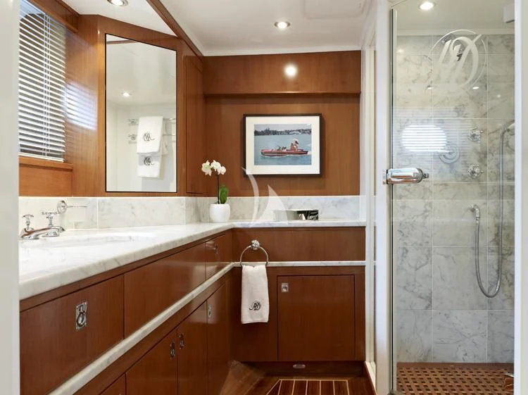 a bathroom with a glass shower aboard HEAVENLY DAZE Yacht for Sale