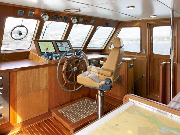 a wooden boat with a steering wheel aboard HEAVENLY DAZE Yacht for Sale