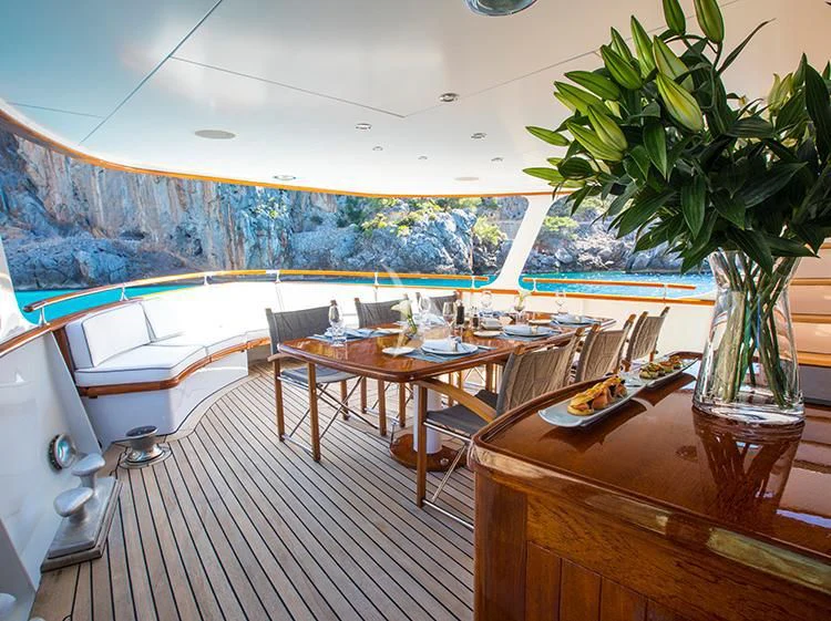 a dining room with a table and chairs aboard HEAVENLY DAZE Yacht for Sale