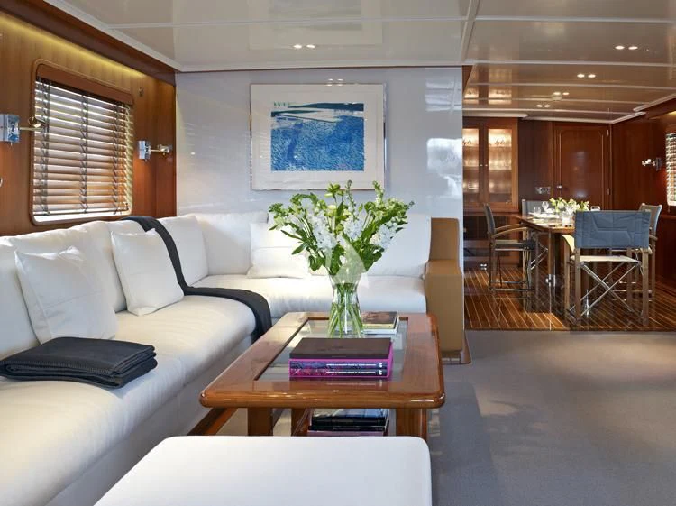 a living room with a table and chairs aboard HEAVENLY DAZE Yacht for Sale