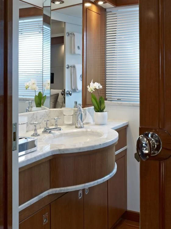 a bathroom with a sink and a mirror aboard HEAVENLY DAZE Yacht for Sale