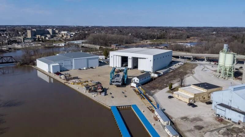 a factory with a river and a blue sky aboard INGOT Yacht for Sale