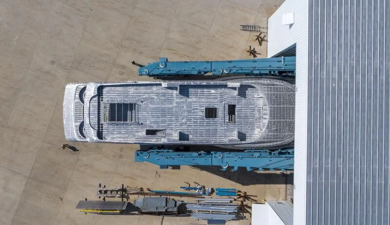 a large white building with a blue roof aboard INGOT Yacht for Sale