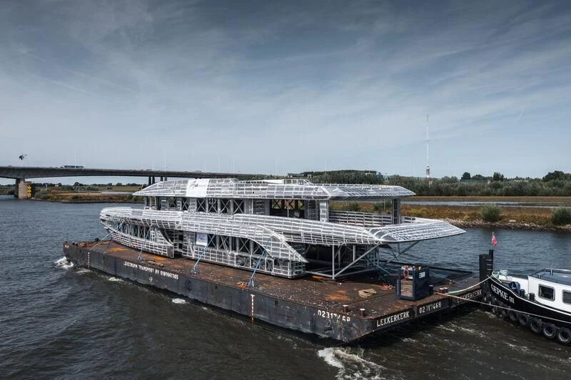 a large cruise ship docked aboard INGOT Yacht for Sale