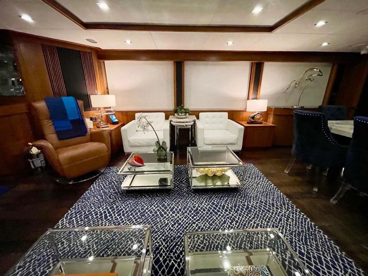 a room with a table chairs and a couch aboard SOLARIS Yacht for Sale
