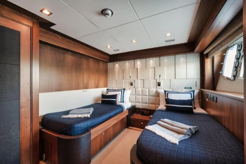 a room with a bed and a couch aboard SOLARIS Yacht for Sale