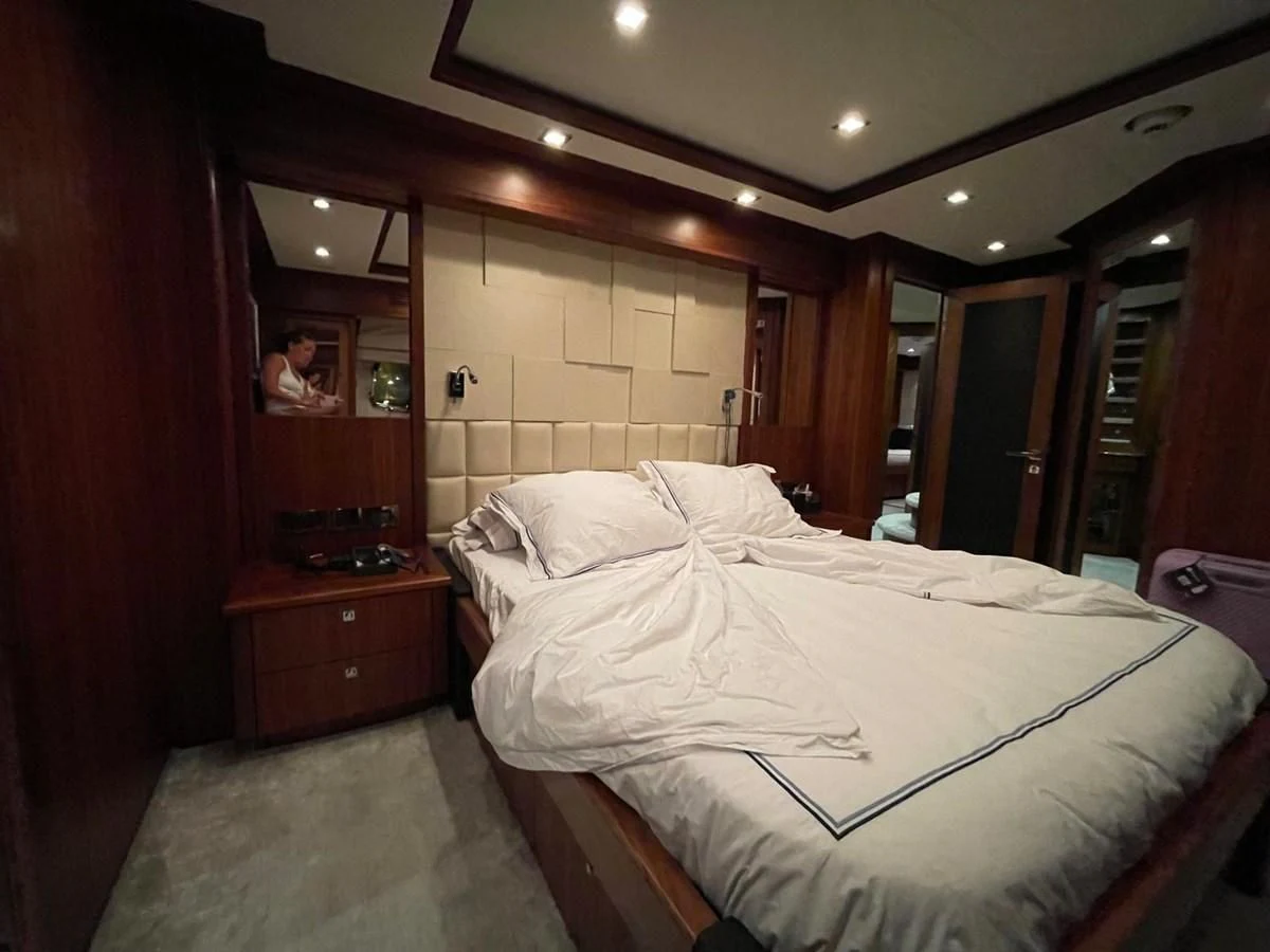 a room with a bed and a mirror aboard SOLARIS Yacht for Sale