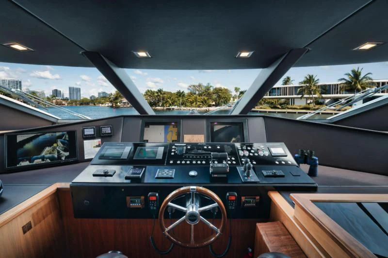 a black and silver console on a wooden table aboard SOLARIS Yacht for Sale