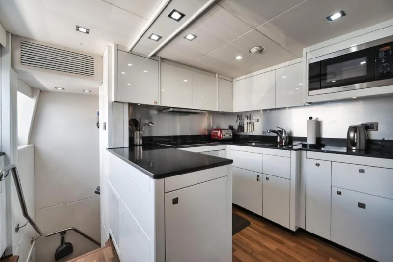 a kitchen with white cabinets aboard SOLARIS Yacht for Sale
