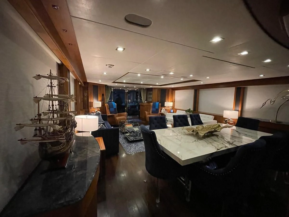 a room with a table and chairs aboard SOLARIS Yacht for Sale