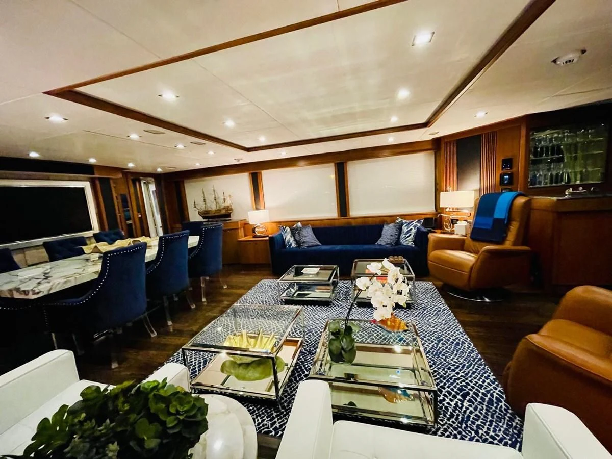 a living room with a large table and chairs aboard SOLARIS Yacht for Sale