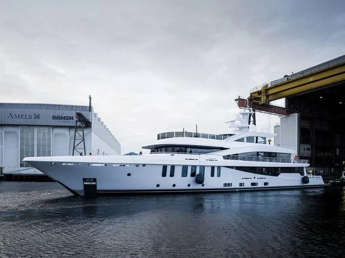 a white yacht docked at a dock aboard MARSA Yacht for Sale