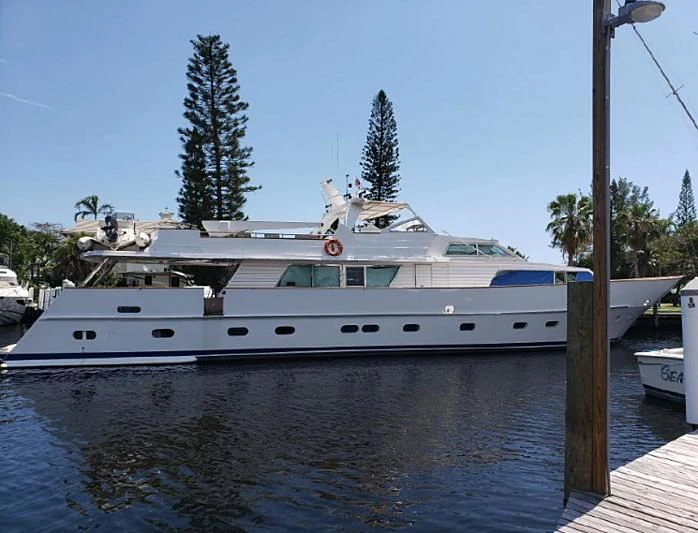 a white boat docked at a pier aboard TROTTER Yacht for Sale