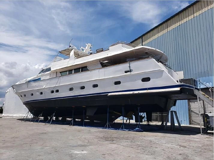 a large white boat on a beach aboard TROTTER Yacht for Sale