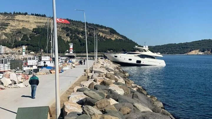 a person standing on a dock next to a boat aboard GEMINI Yacht for Sale
