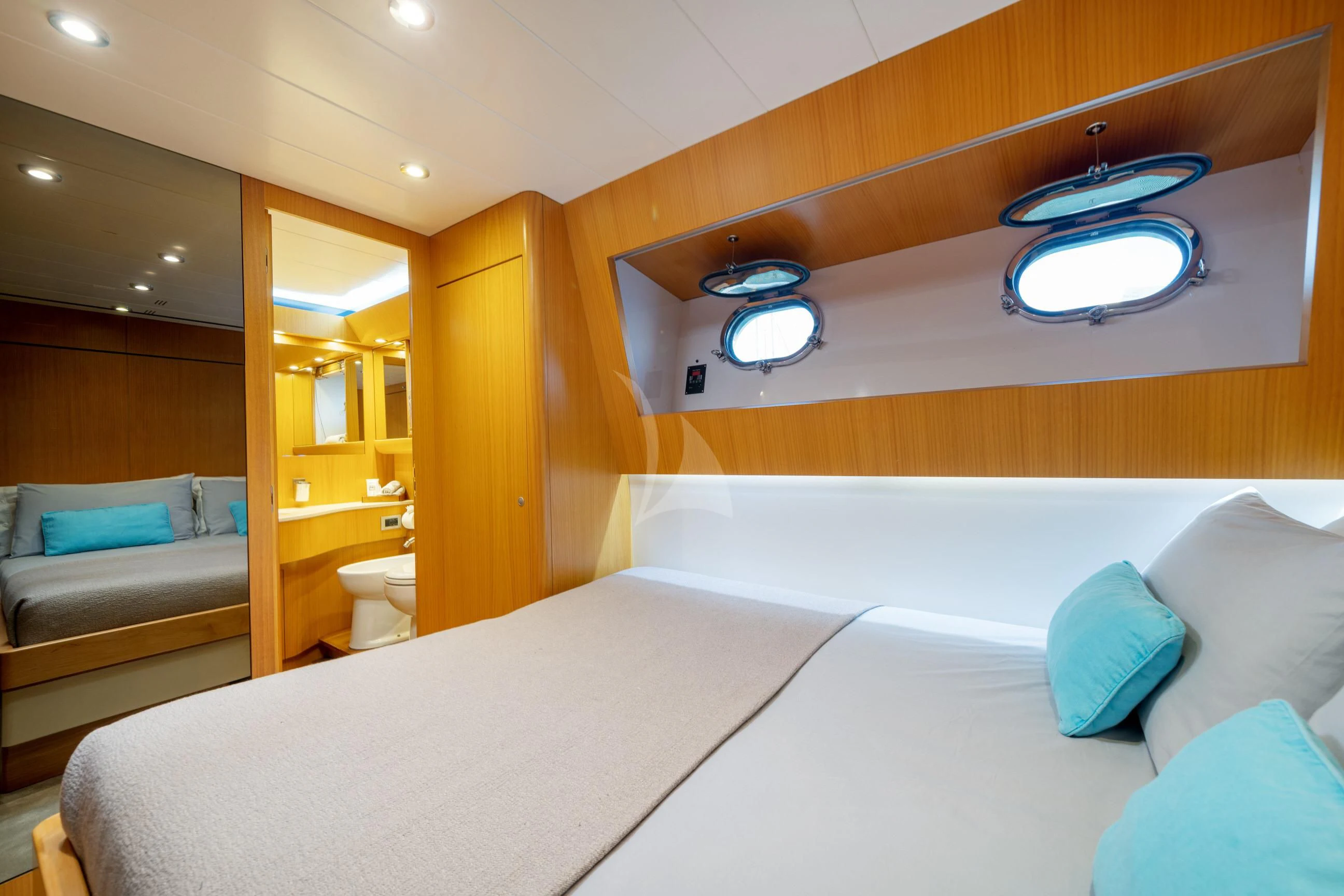 a bed with a white bed aboard MINOU Yacht for Sale